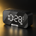 Black mirror digital alarm clock on black and gold background