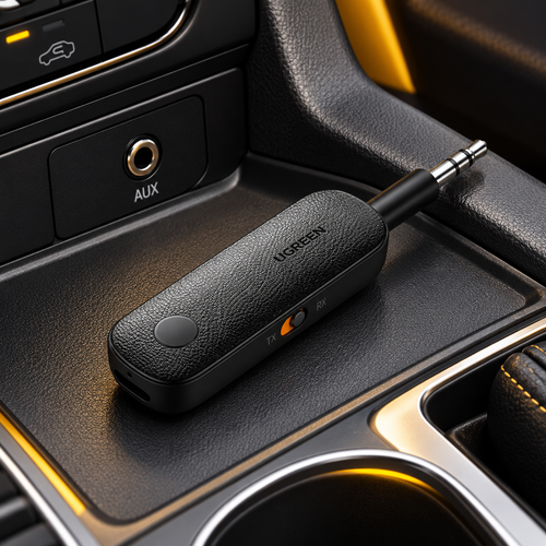 Black Bluetooth AUX adapter beside the car audio input
