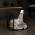 Black single-layer foldable mesh laundry basket in a modern laundry room