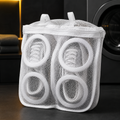 Protective shoe washing bag in a black and yellow laundry room